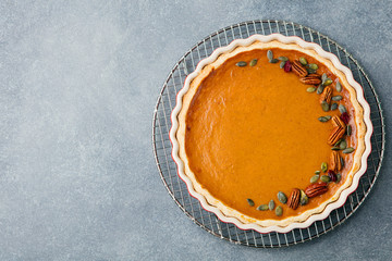 Tasty pumpkin pie, tart made for Thanksgiving day in a baking dish Top view Copy space