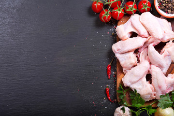 fresh raw chicken wings with vegetables
