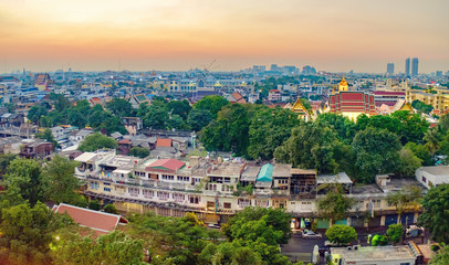 Fototapeta premium Traditional architecture of Bangkok from the height of bird flight. View of Wat Ratchanatdaram Temple from Golden Mountain at sunset, Thailand.