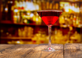 red cocktail on wooden table