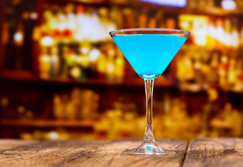 blue cocktail on wooden table