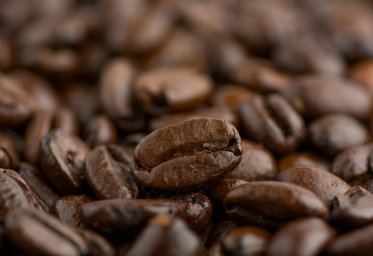 Closeup of coffee beans with focus on one © Vladyslav Bashutskyy