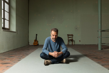 Portrait of man with guitar, the industrial location