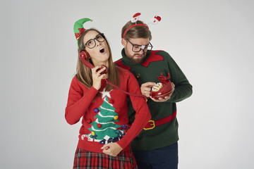 Christmas couple calling by retro telephone