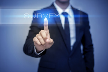 Businessman hand touching SURVEY button on virtual screen