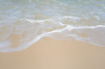 Fototapeta na wymiar Sea waves and beautiful beach and white sand, with blue water