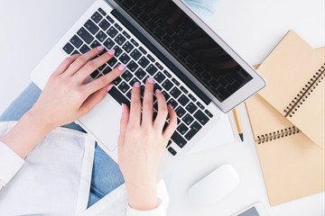 Fototapeta na wymiar Female hands typing on laptop keyboard