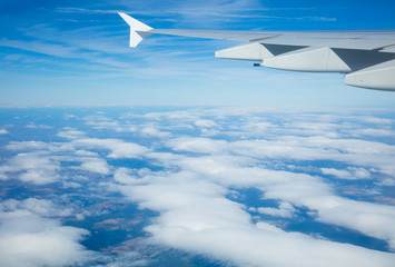 Naklejka na ściany i meble Beautiful airplane view above clouds