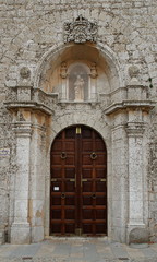 Fototapeta na wymiar Old gate in church in Ibiza Town, Balearic Isnalds, Spain