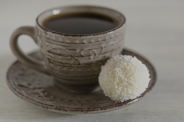 White coconut candy with cup of coffee