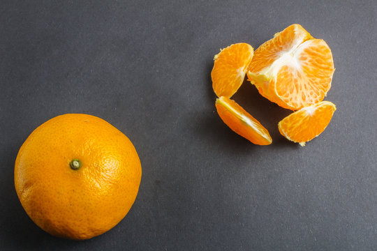 Orange mandarin or tangerine fruit on black background