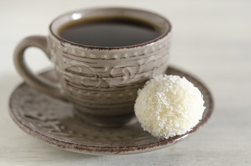 White coconut candy with cup of coffee