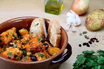 Italian codfish alla ghiotta in a terracotta casserole.