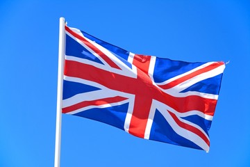 Union jack flag against a blue sky.