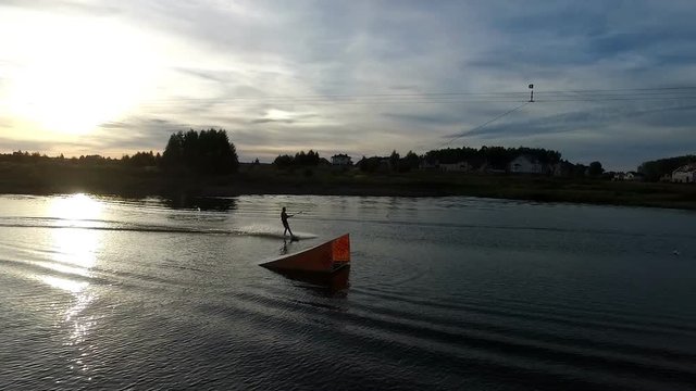 Aerial view of wakeboarding at sunset