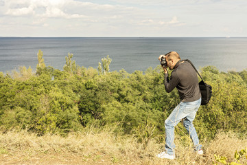 Beautiful sea landscape. A man photographs the sea and the sky.