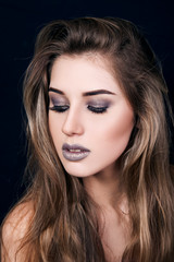 Fototapeta premium The girl, a woman, a beautiful young girl with professional make