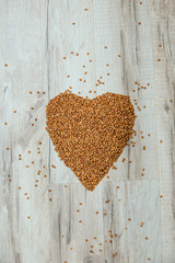 Buckwheat on a wooden background. The concept of healthy eating.
