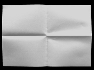 white uneven sheet of paper on the black background