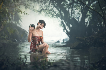 Asian sexy woman bathing in creek, Thailand