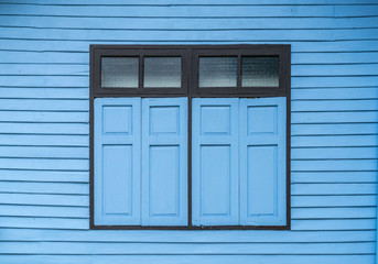 Window on blue wooden wall