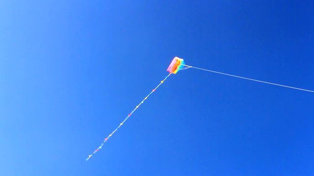 Colorful kite flying in the blue sky