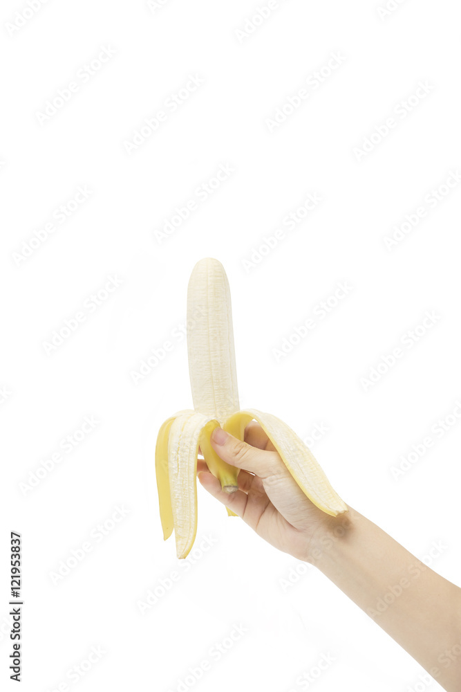 Wall mural the peeled banana in a female hand isolated on white with clipping path