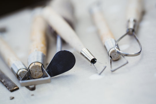 A row of hand tools for potters on a workbench. Wire shaping tools. 