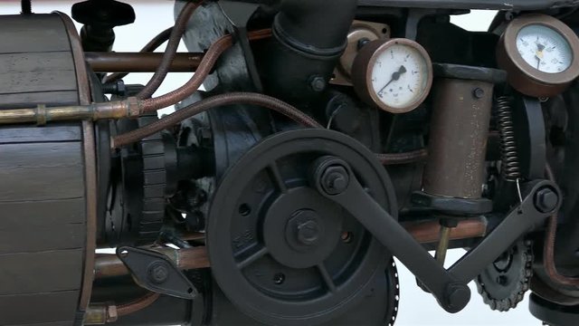 Panning over old black-brown steam engine.