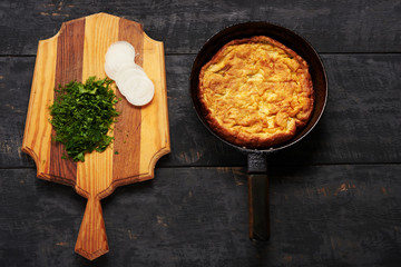 eggs omelet, herbs and onions on a table