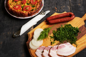 bread, sausage, scrambled eggs, bacon on a table