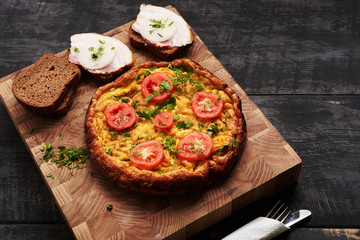 bread, scrambled eggs, bacon on a table