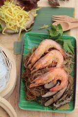 Baked shrimp with vermicelli and celery leaves.