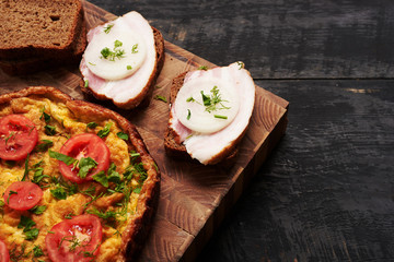 bread, scrambled eggs, bacon on a table