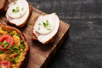 bread, scrambled eggs, bacon on a table