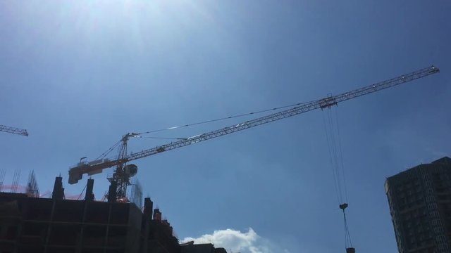 Building Under Construction, Crane against the blue sky