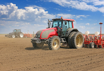 Tractors and Seeder Planting Crops on a Field