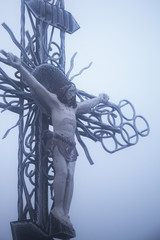 the crucifixion of Jesus Christ (statue in snow and fog)