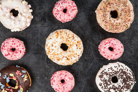 Tasty donuts on dark background