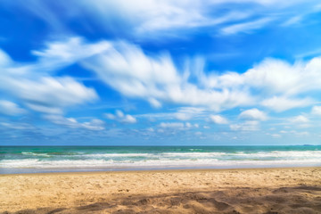 Fototapeta na wymiar sandy beach with sea and cloudy sky