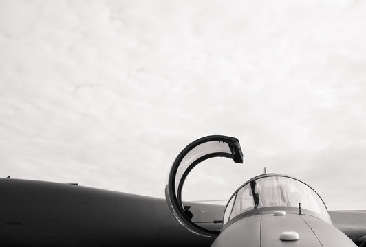 Detail Of Military Fighter Plane From The Front Side - Cockpit Of Airplane Is Open And Prepared For Pilot. Black And White, Copy Space With Large Area Of Cloudy Sky 