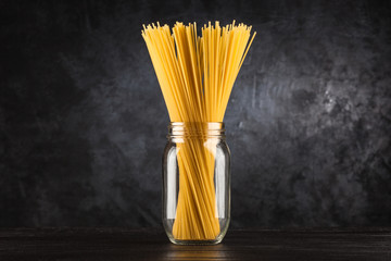 Raw spaghetti on dark background