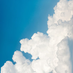 Naklejka na ściany i meble Beautiful white fleecy cloud on blue sky background. Squared ima