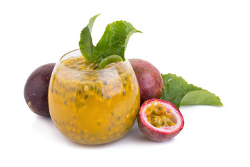 Fresh passion fruit juice with passion fruits on white
