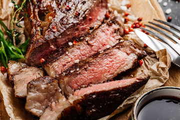 Beef rump steak from marble beef medium rare with sauce on wood