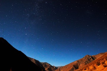 Stargazing in Elqui Valley with hundreds of stars in the sky between black hills in Chile, South America © mandy2110