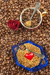Coffee beans and instant coffee. Granules of instant coffee background. Instant coffee in a glass dish. Preparation of soluble coffee. Decorate store coffee.
