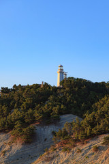 Fototapeta na wymiar white lighthouse with a blue sky