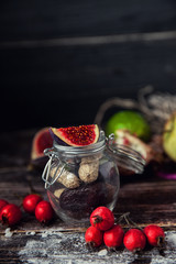 Colorful fruit salad in a jar on rustic wooden background
