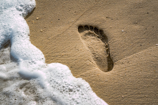 Footprint in Sand with Wave